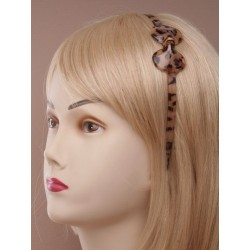 narrow plastic animal print aliceband with plastic bow....
